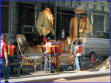 Worker conference reflected in store window